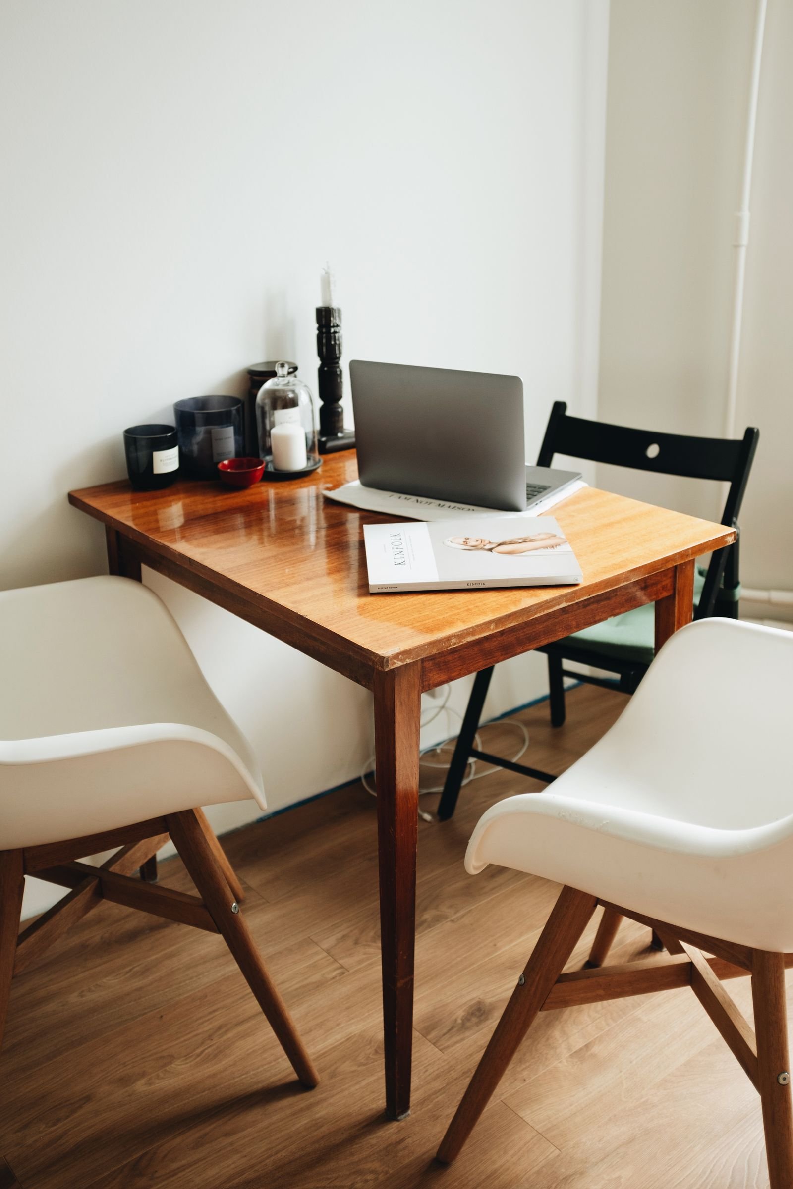 Warm home office with a wooden table, notebook and lamp