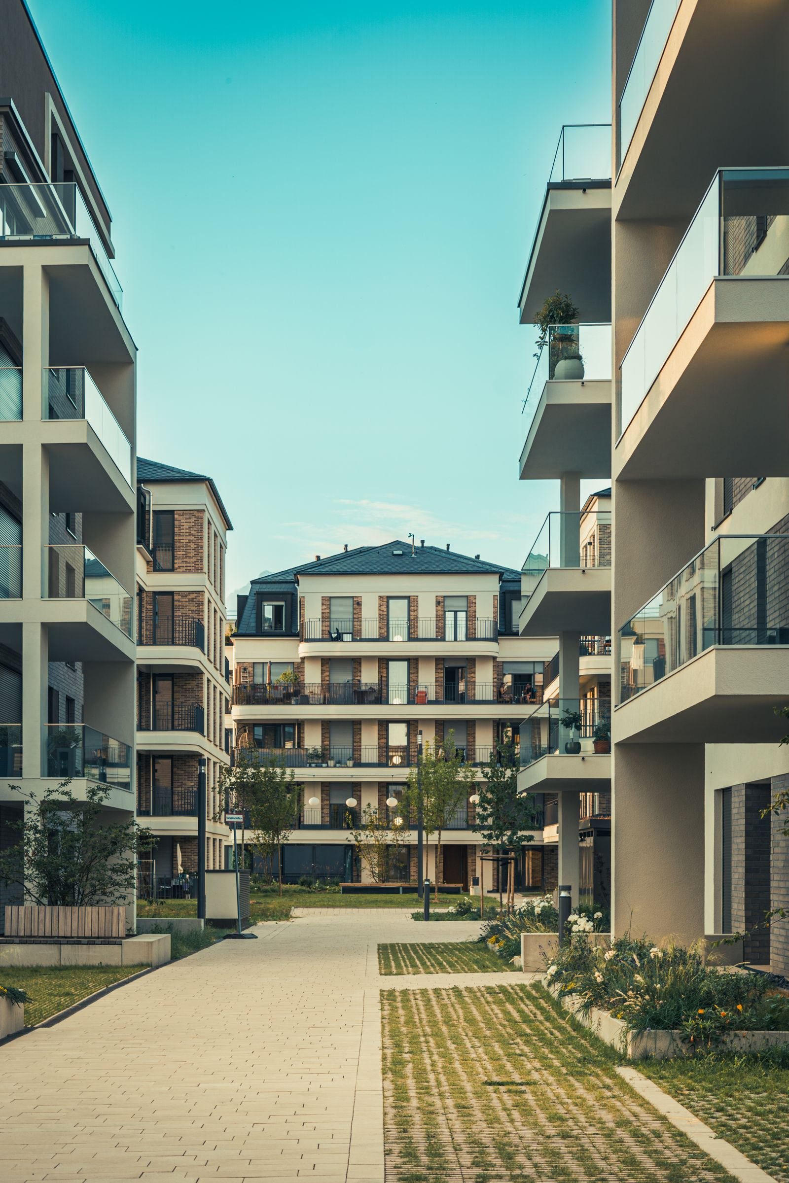 Walkway between two modern apartment buildings with balconies