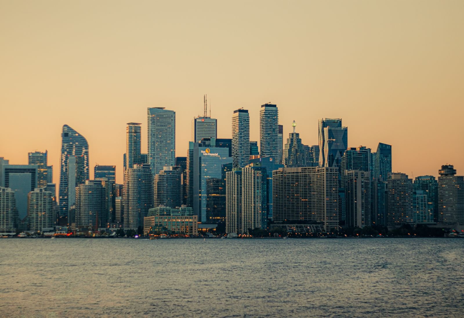 Toronto skyline at sunset with the downtown towers lit by low light